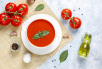 Tomato soup with basil in a bowl.