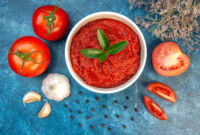 top-view-fresh-tomatoes-with-tomato-paste-garlic-blue-table